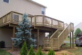 Large 2nd story treated deck with 2 landings and steps to the ground 
